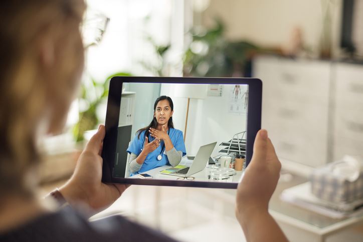 Woman meeting with her doctor through a telehealth visit on her iPad
