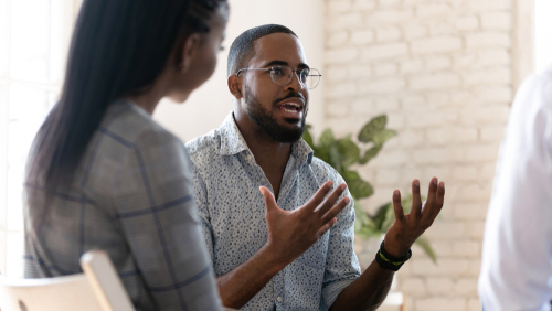 African American male talking amongst his therapy group