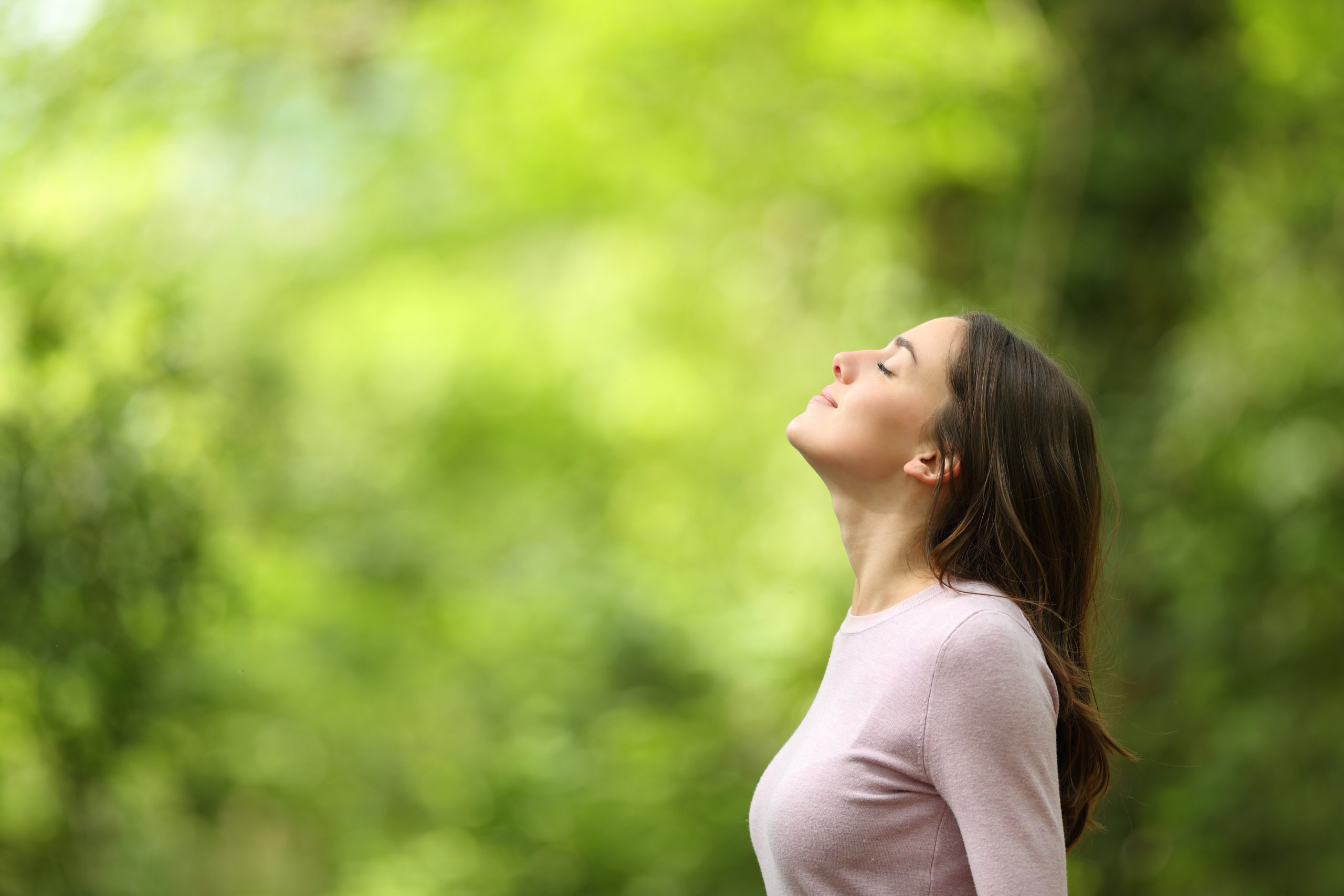 relaxed woman breathing in fresh air